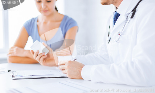 Image of patient and doctor prescribing medication