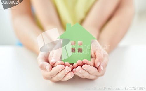 Image of close up of woman and girl hands with paper house