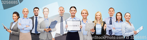 Image of group of happy businesspeople holding contract