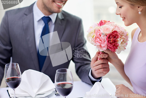 Image of young couple with glasses of wine at restaurant