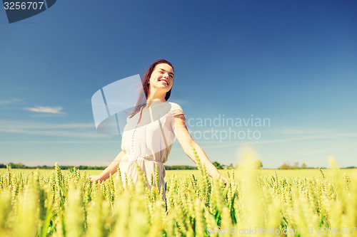 Image of smiling young woman on cereal field