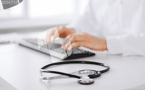 Image of male doctor typing on the keyboard