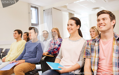Image of group of smiling students in lecture hall