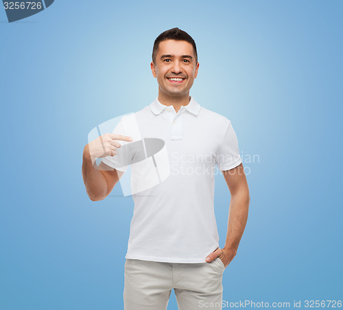 Image of smiling man in t-shirt pointing finger on himself