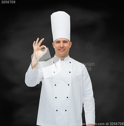 Image of happy male chef cook showing ok sign