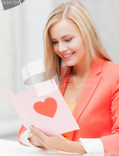 Image of woman holding postcard with heart shape