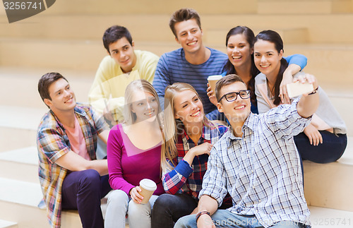 Image of group of students with smartphone and coffee cup