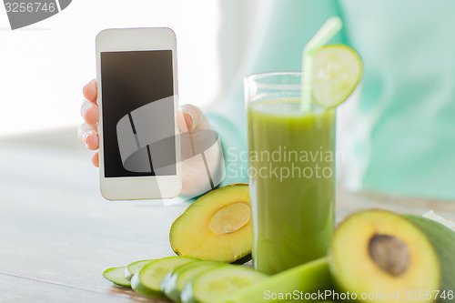 Image of close up of woman with smartphone and vegetables