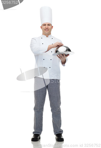 Image of happy male chef cook holding cloche