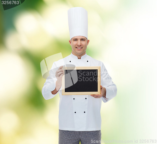 Image of happy male chef cook holding blank menu board