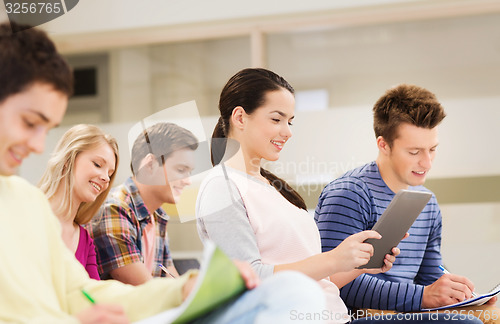 Image of group of smiling students with tablet pc