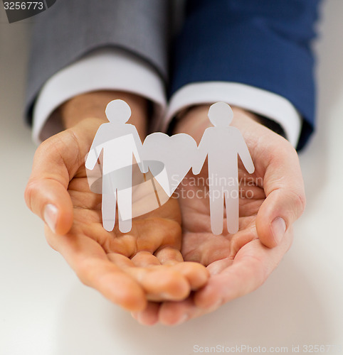 Image of close up of happy male gay couple with love symbol