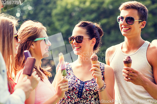 Image of group of smiling friends with ice cream outdoors