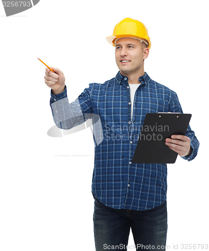 Image of smiling man in helmet with clipboard