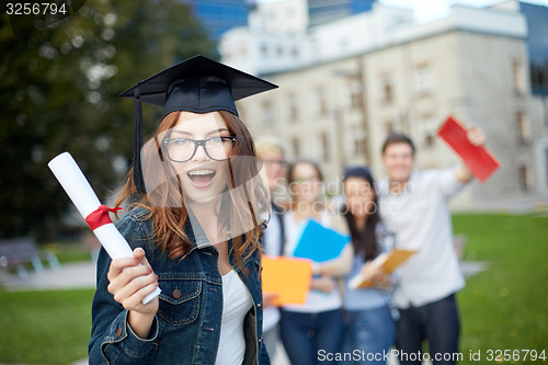 Image of group of smiling students with diploma and folders