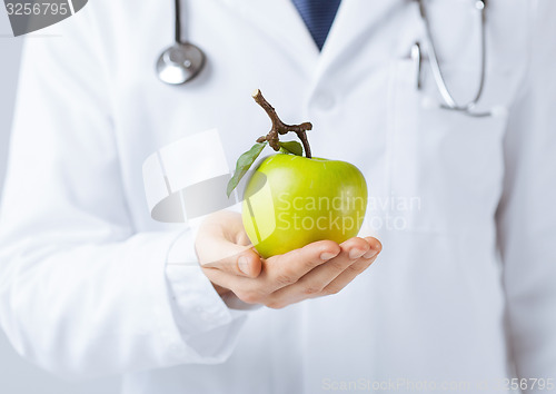 Image of male doctor with green apple