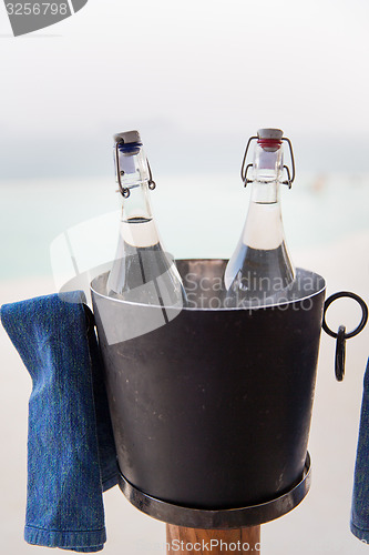 Image of water bottles in ice bucket at hotel beach