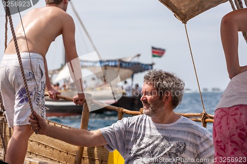 Image of Tourists enjoying sea on yacht. Ship traveling in Kenya