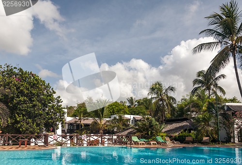 Image of Swimming pool, palm trees and sky