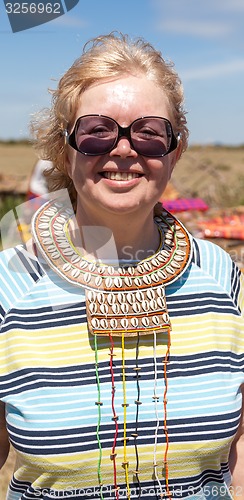 Image of Portrait of woman wearing traditional handmade accessories, Kenya