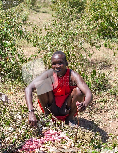 Image of MASAI MARA,KENYA, AFRICA- FEB 12  Masai man is preparing a potion in traditional clothes, review of daily life of local people,near to Masai Mara National Park Reserve, Feb 12, 2010,Kenya