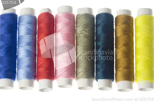 Image of Row of colorful sewing threads

