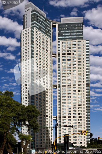 Image of skyscraper clouds and traffic lights