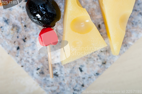 Image of mix cold cut on a stone with fresh pears