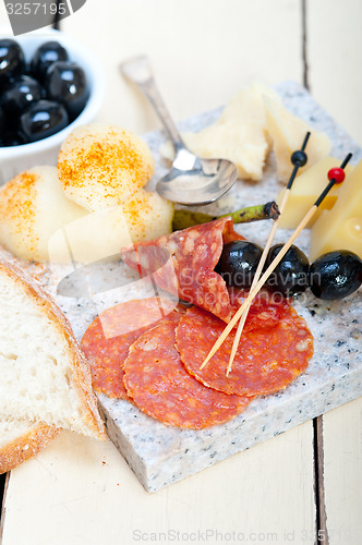 Image of mix cold cut on a stone with fresh pears