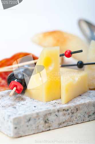 Image of mix cold cut on a stone with fresh pears