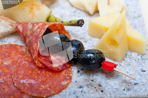 Image of mix cold cut on a stone with fresh pears