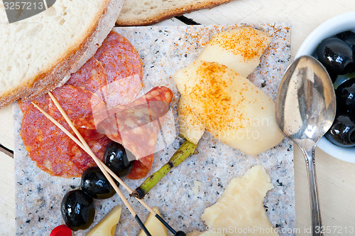 Image of mix cold cut on a stone with fresh pears