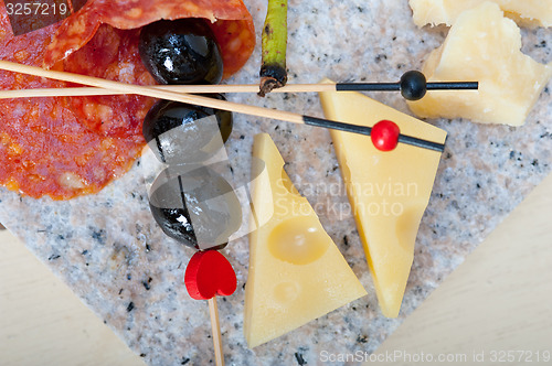 Image of mix cold cut on a stone with fresh pears