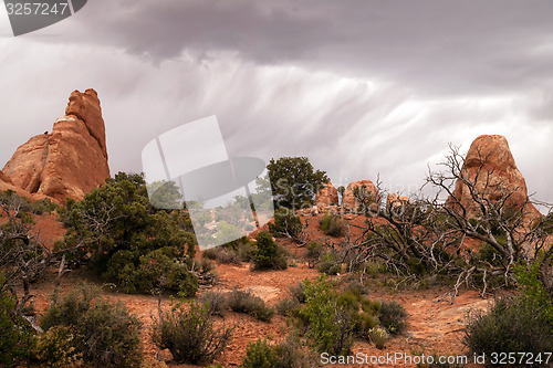 Image of Rain Streaks Clouds Rock Formations Utah Juniper Trees