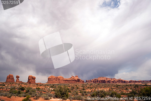 Image of Rain Streaks Clouds Above Rock Formations Utah Juniper Trees