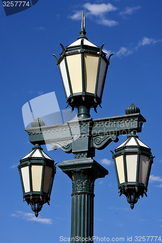 Image of old green street lamp and clouds 