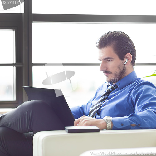 Image of Businessman in office working on his laptop. 