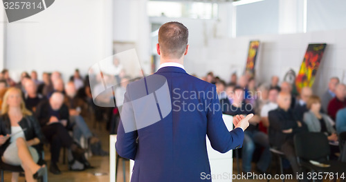 Image of Speaker at Business Conference and Presentation.