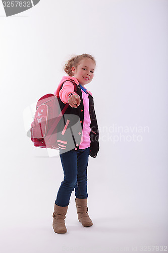 Image of Girl with school bag points with the finger in the camera