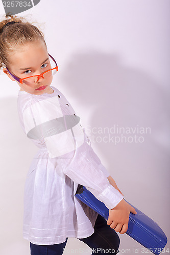 Image of Basic school child with heavy file in the hand