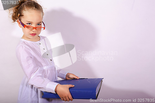 Image of Basic school child with file in the hand and pencil behind the ear