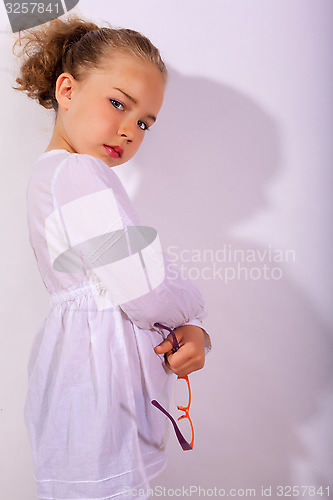 Image of Blond girl with crossed arms and glasses in the hand