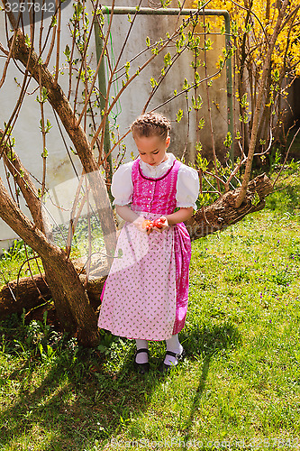 Image of Girl in the dirndl is bored with coloured ones wobble in the hand