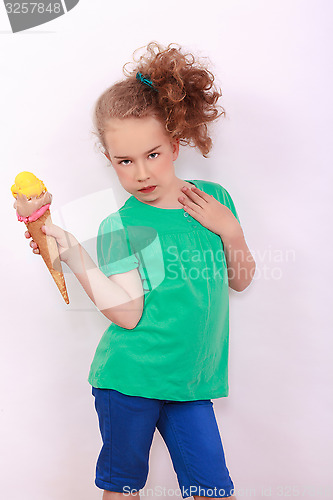 Image of Young blond girl with ice-cream cone in the hand