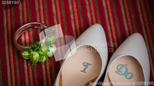 Image of wedding shoes and bouquet 