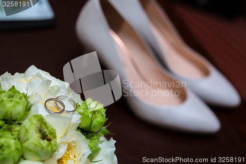 Image of wedding shoes and bouquet 