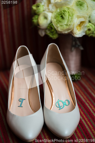 Image of wedding shoes and bouquet 