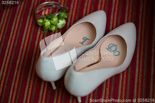 Image of wedding shoes and bouquet 