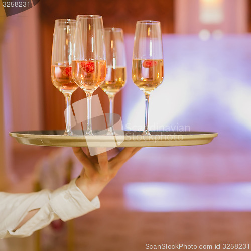 Image of Waiter serving champagne on a tray