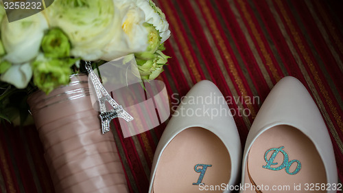 Image of wedding shoes and bouquet 